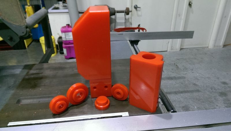 A table saw with a bunch of orange parts on it - Engineering Tooling In Thornton, NSW