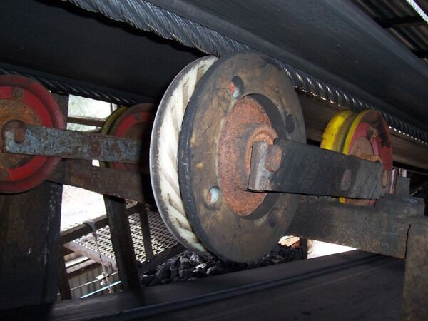 A close up of a conveyor belt with wheels on it - Engineering Tooling In Thornton, NSW