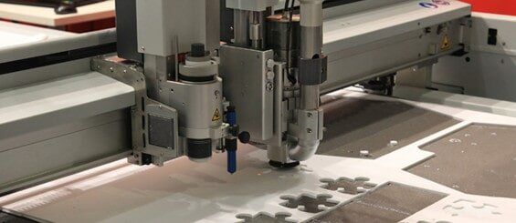 A Machine is Cutting a Piece of Paper on a Table - Engineering Tooling In Thornton, NSW