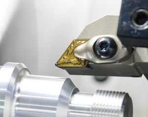 A machine is cutting a piece of metal on a machine - Engineering Tooling In Thornton, NSW