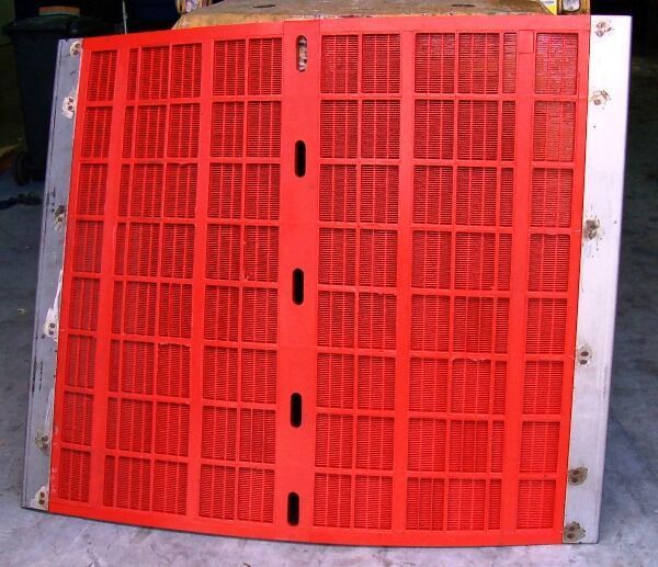 A red screen with holes in it is sitting on the ground - Engineering Tooling In Thornton, NSW