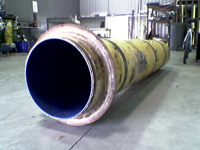 A large yellow and blue pipe is sitting on the floor - Engineering Tooling In Thornton, NSW