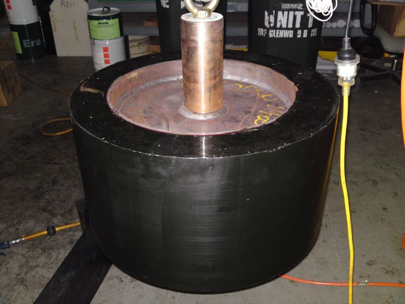 A large black cylinder with a copper cylinder in the middle - Engineering Tooling In Thornton, NSW