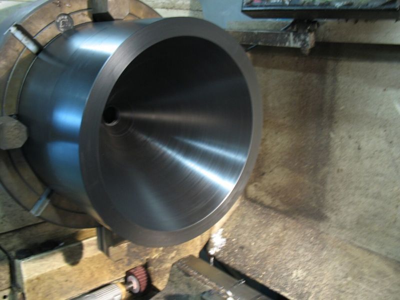 A large metal cone is being turned on a lathe - Engineering Tooling In Thornton, NSW
