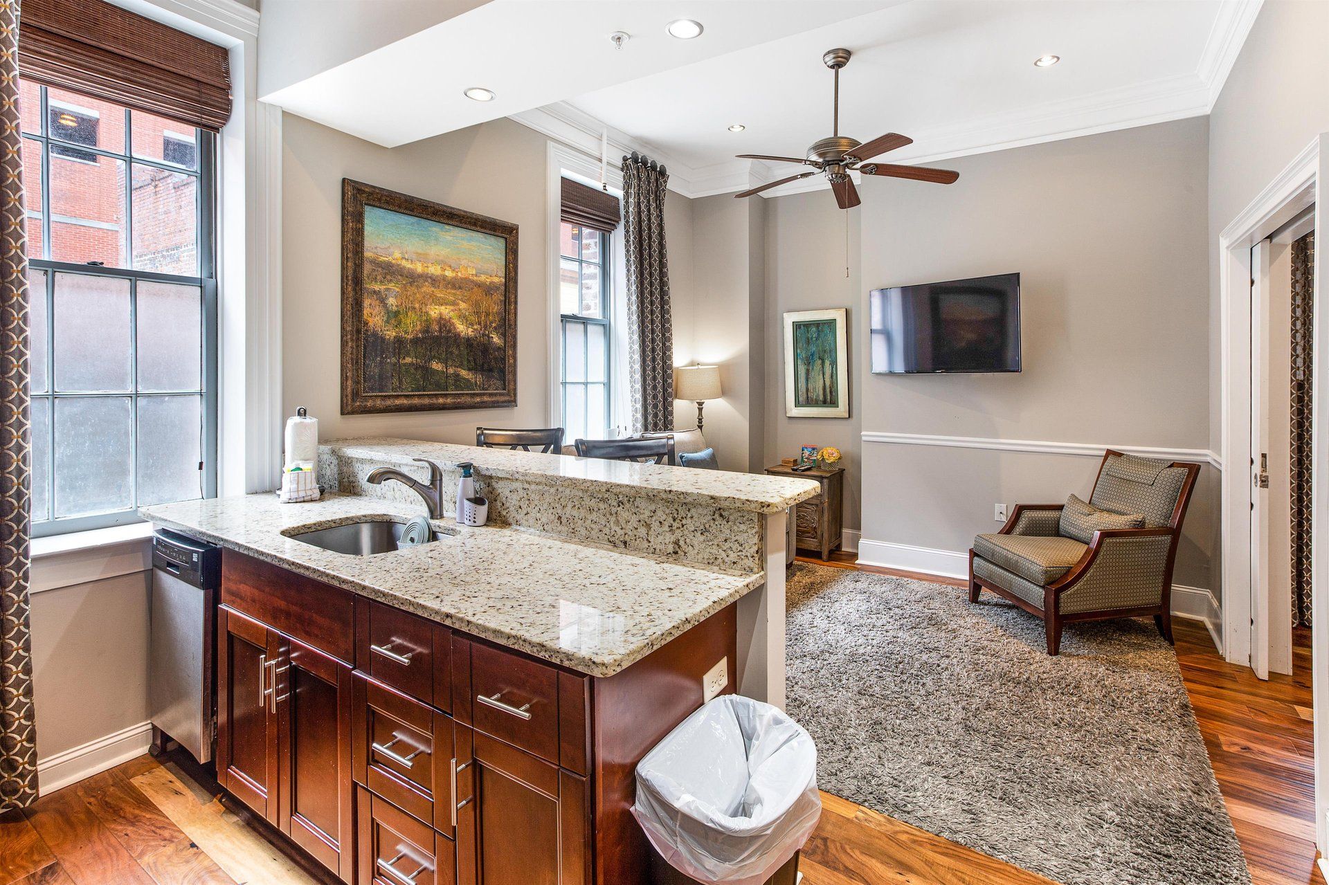 Small studio apartment with kitchenette, living area, and window.