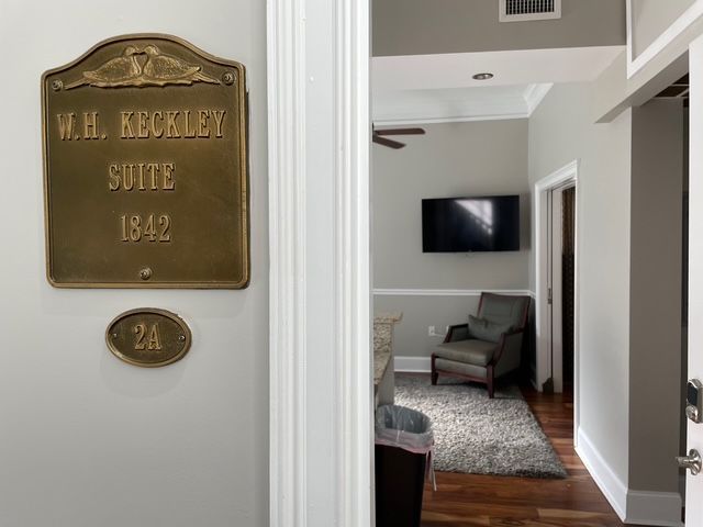 Brass sign on a wall reading 