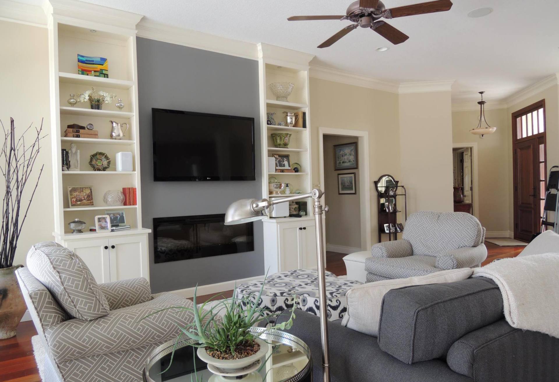 A living room with a fireplace and a flat screen tv