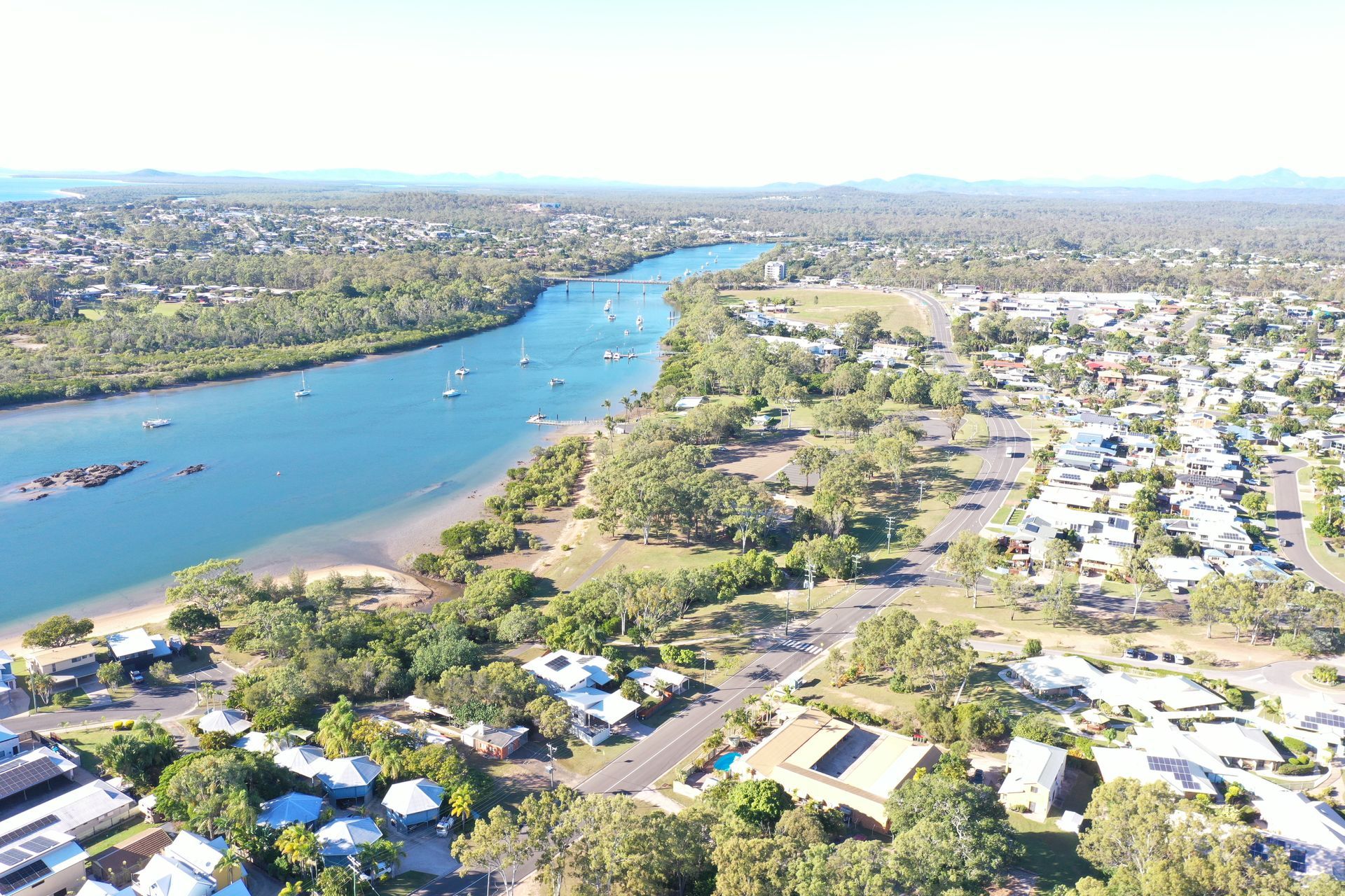 A River With Boats in It and a City in the Background — Werry Building Services in Gladstone, QLD
