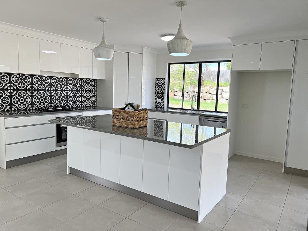 An Empty Bedroom With a Ceiling Fan and a Large Window — Werry Building Services in Boyne Island, QLD