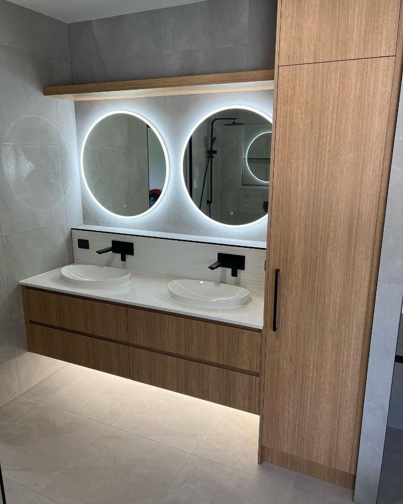 A Bathroom With Two Sinks, a Bathtub and a Walk in Shower — Werry Building Services in Boyne Island, QLD