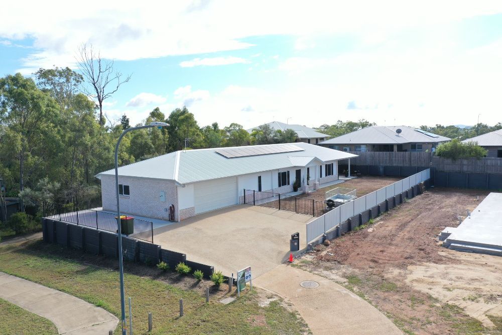 A White House With a Balcony and a Blue Sky in the Background — Werry Building Services in Boyne Island, QLD