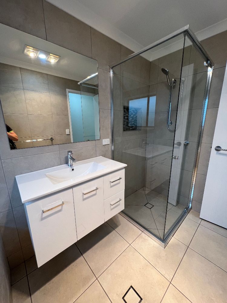 A Kitchen With a Lot of Shelves and a Sliding Glass Door — Werry Building Services in Boyne Island, QLD