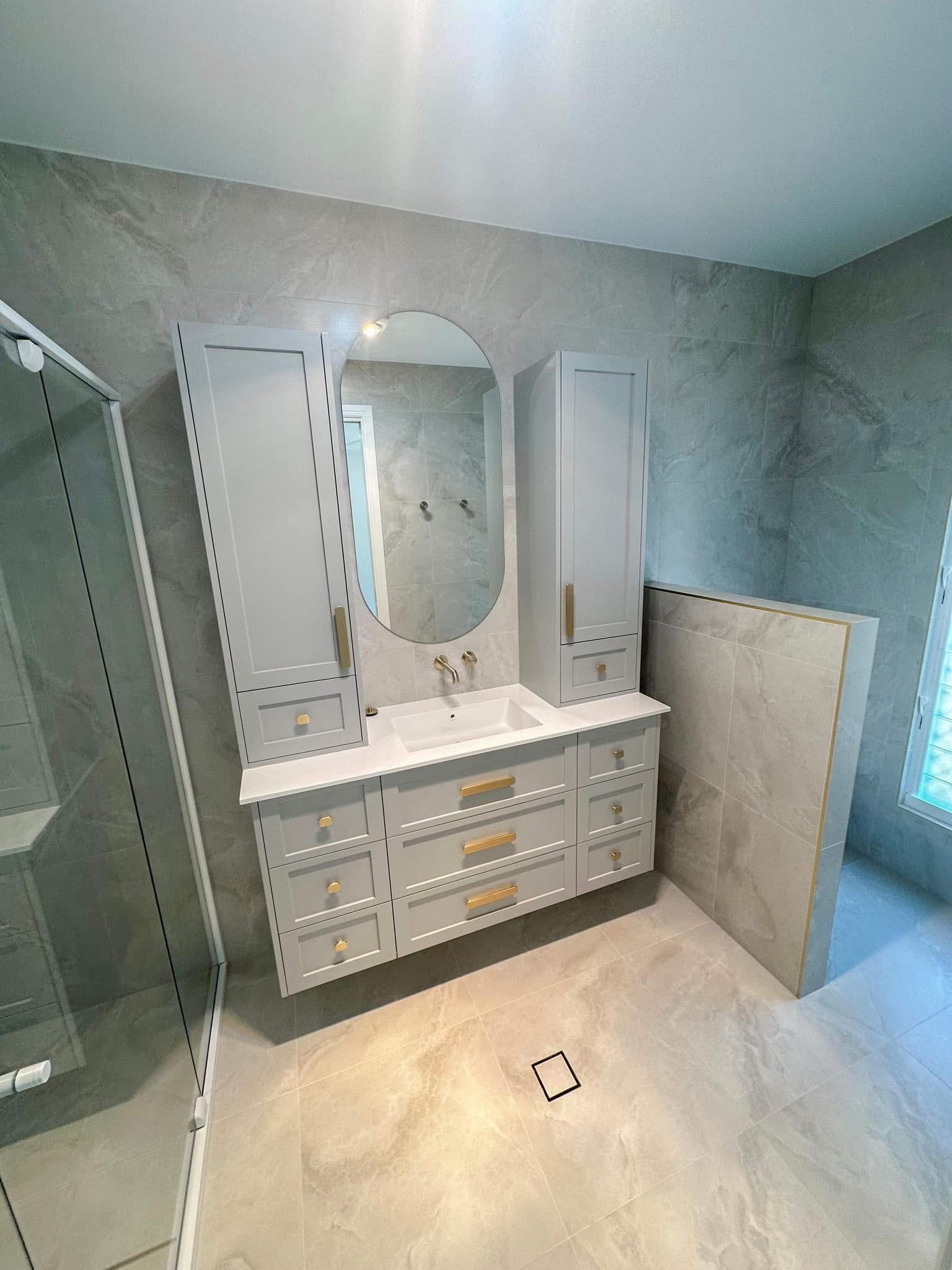 A Bathroom With a Bathtub, Sink, Mirror and Walk in Shower — Werry Building Services in Boyne Island, QLD