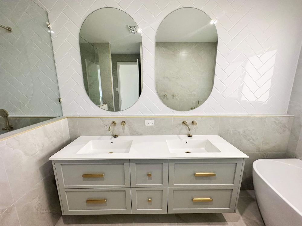 A Bathroom With a Bathtub, Sink, Mirror and Walk in Shower — Werry Building Services in Boyne Island, QLD