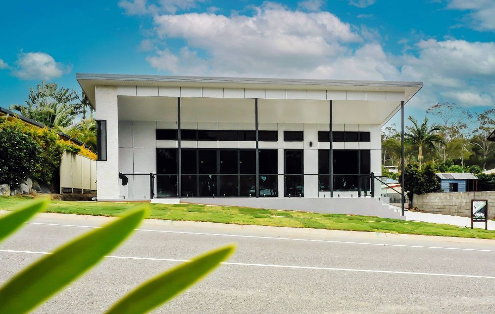 A Bathroom With Two Sinks and a Large Mirror — Werry Building Services in Boyne Island, QLD