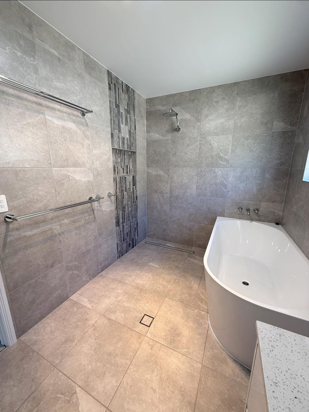 A Bathroom With a Bathtub, Sink, Mirror and Walk in Shower — Werry Building Services in Boyne Island, QLD