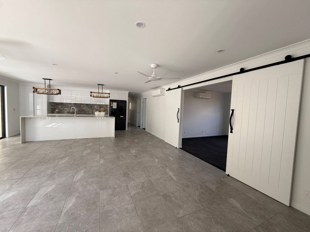 A Bathroom With a Bathtub and a Walk in Shower — Werry Building Services in Boyne Island, QLD