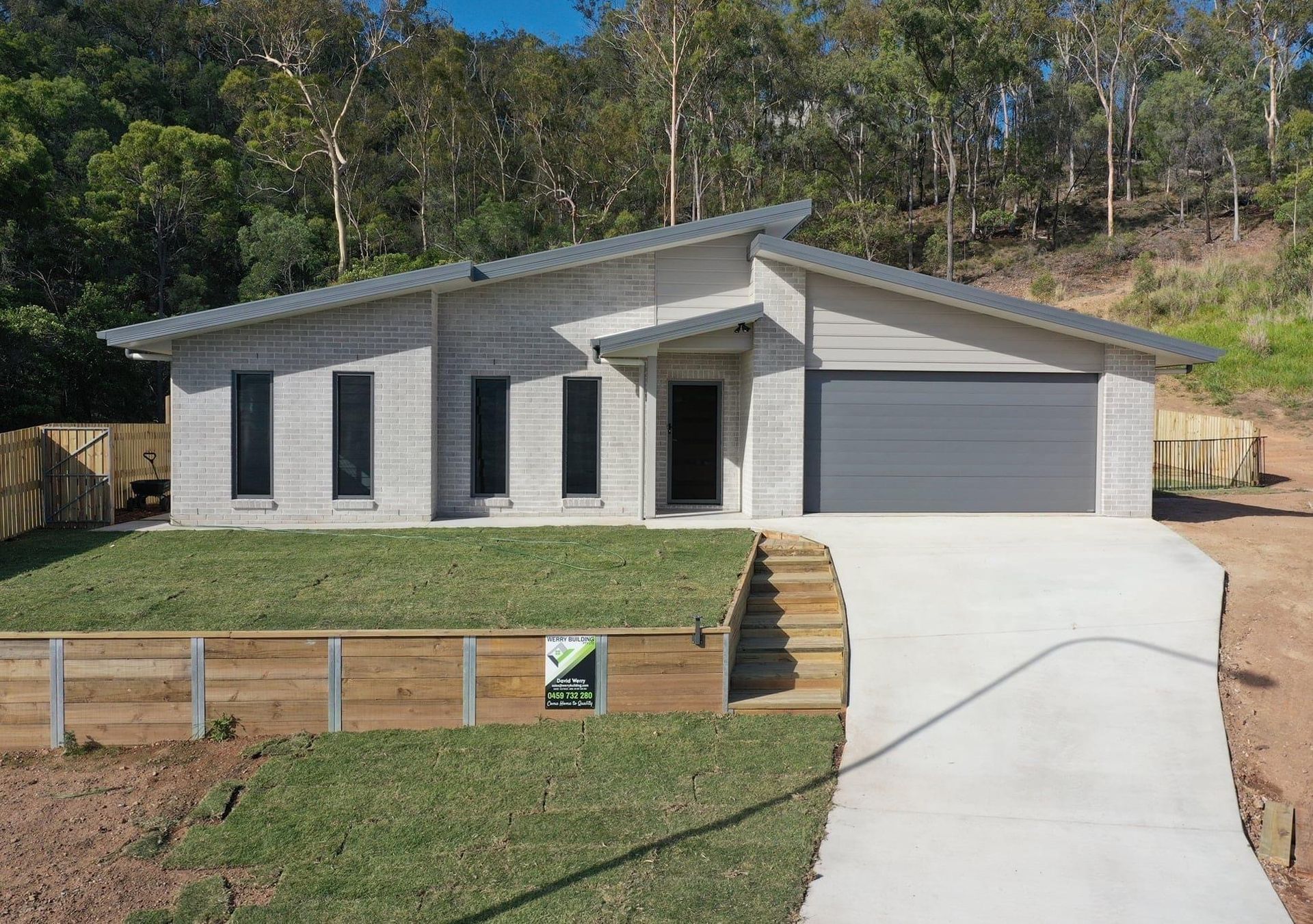 A Bathroom With Two Sinks and a Walk in Shower — Werry Building Services in Boyne Island, QLD