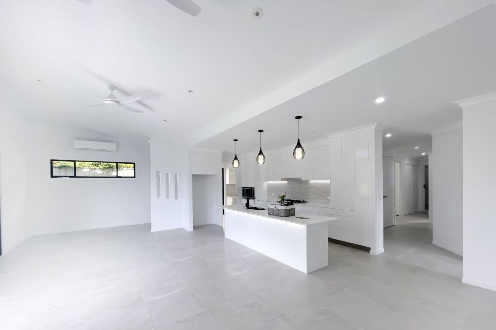 A Bathroom With a Sink, Mirror and Shower — Werry Building Services in Boyne Island, QLD
