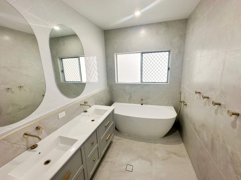 An Aerial View of a House With a Driveway Leading to It — Werry Building Services in Boyne Island, QLD