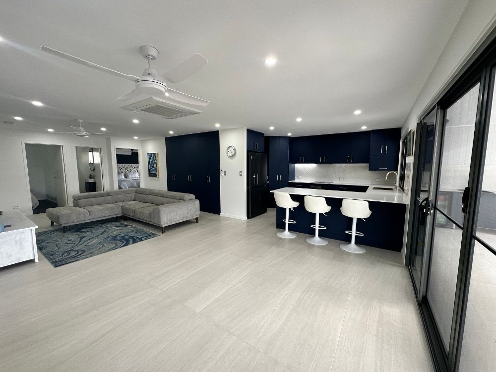 An Empty Room With a Ceiling Fan and a Window — Werry Building Services in Boyne Island, QLD