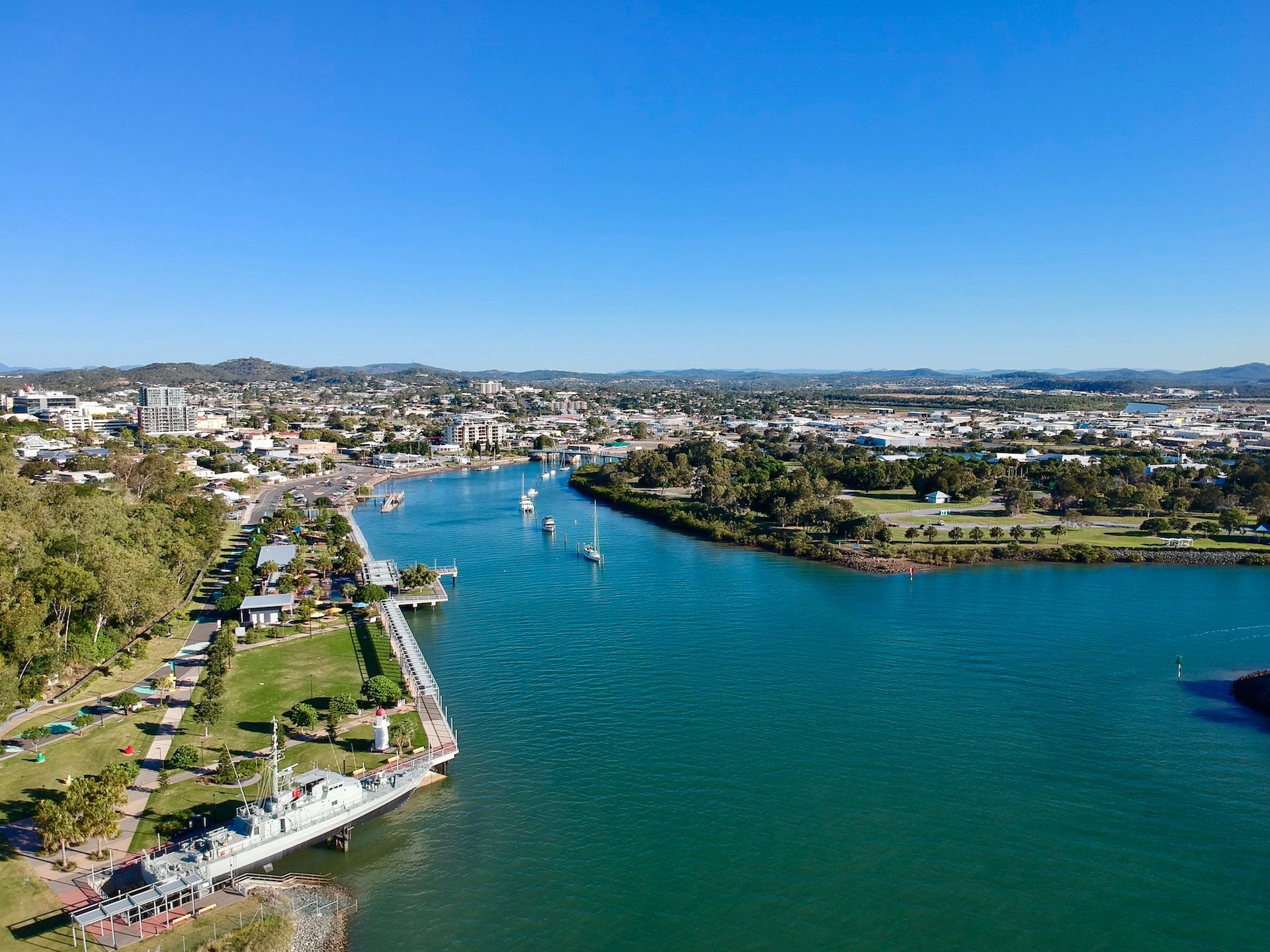 A River With Boats in It and a City in the Background — Werry Building Services in Gladstone, QLD