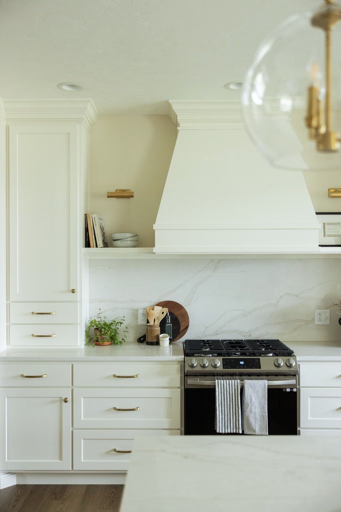 A corner oven with numerous shelves and cabinets for the storing of useful cooking supplies and ingredients.