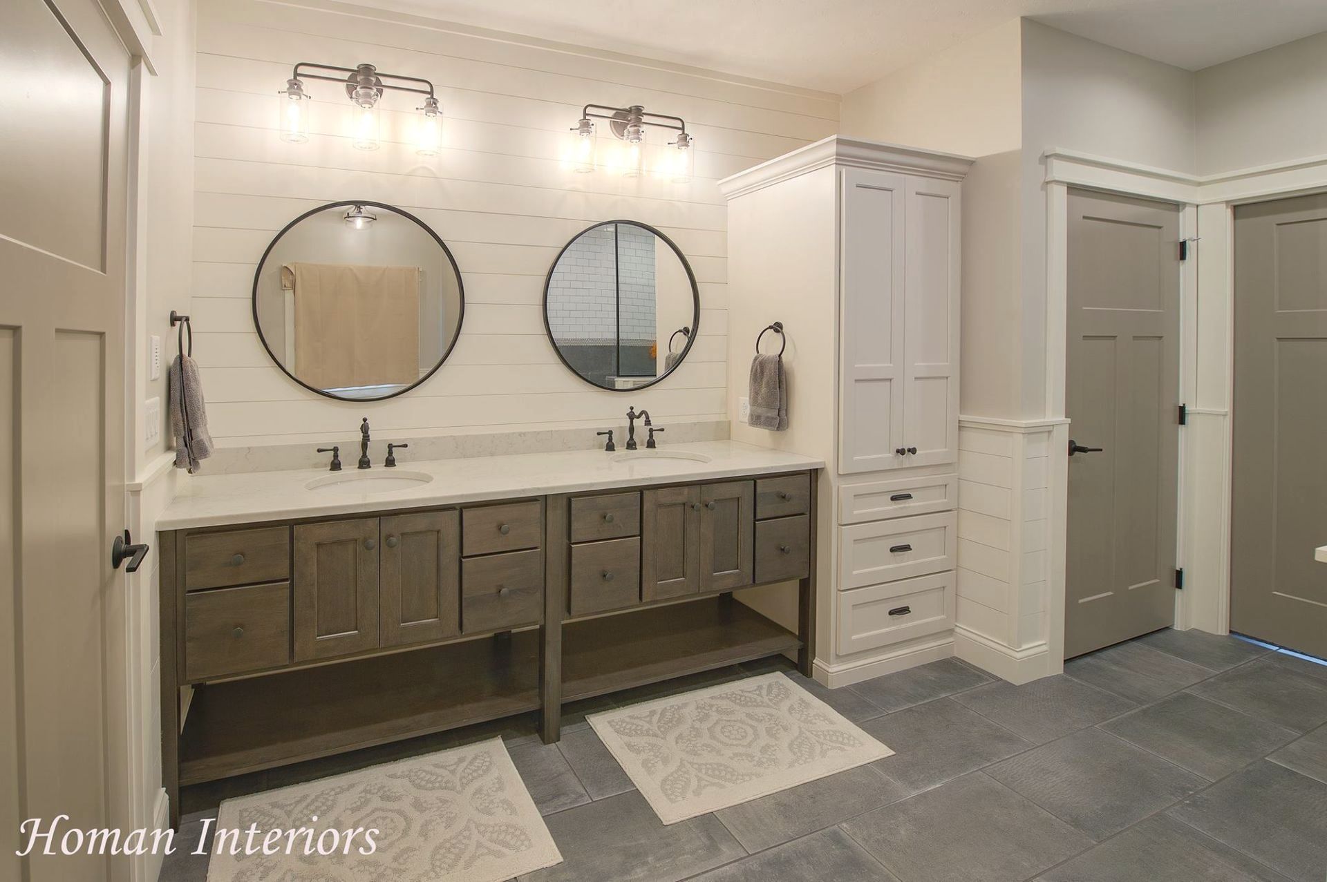 Two sinks and a large cabinet for toiletries. 