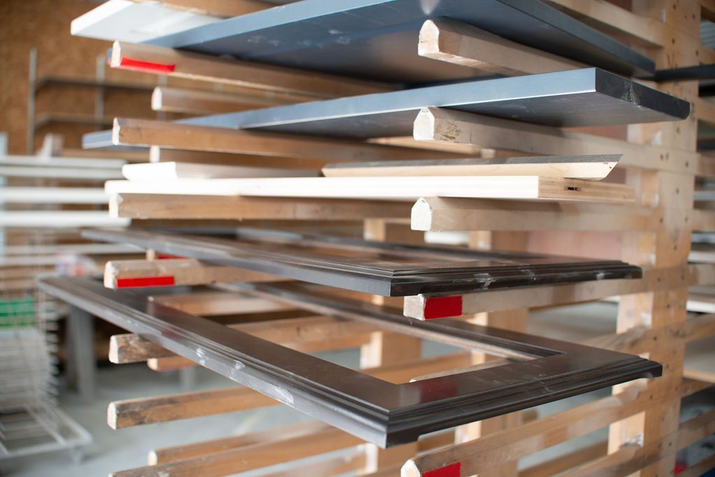 Pre-cut wooden frames stacked on a shelf.