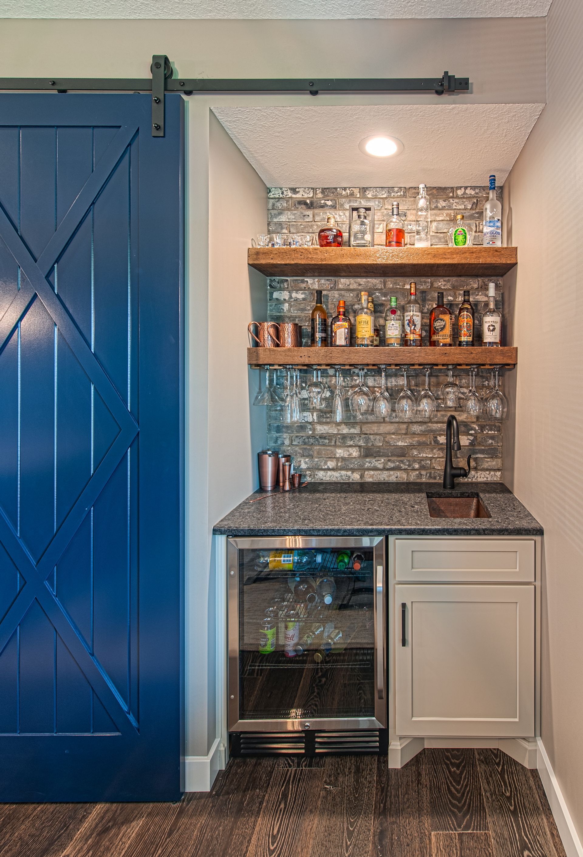 A mini bar with a mini fridge for drinks to mix together.
