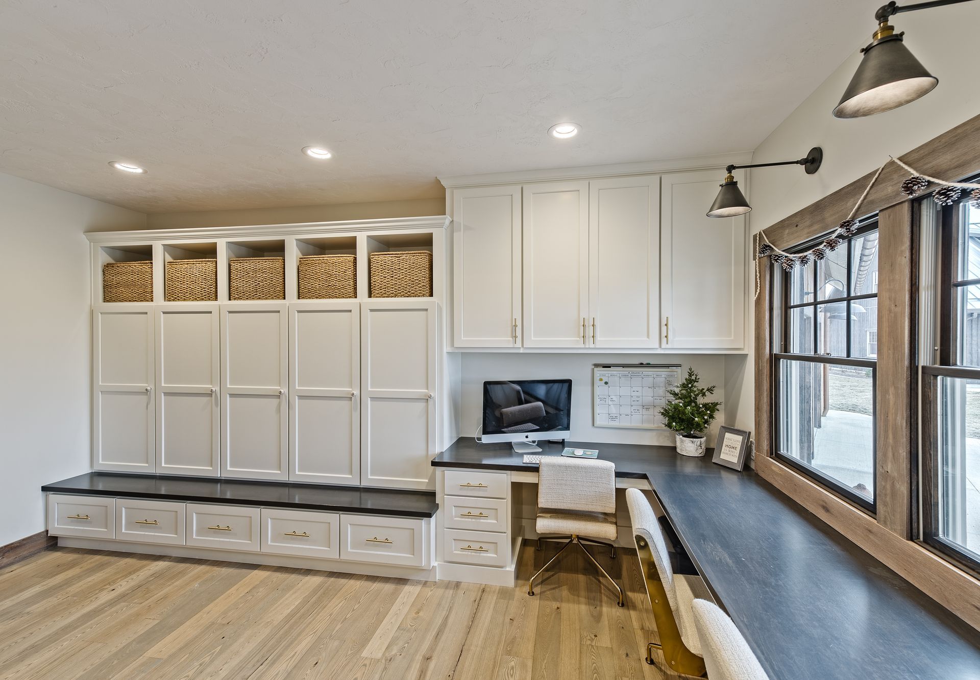 An office room with numerous cabinets for hanging backpacks and other clothes.