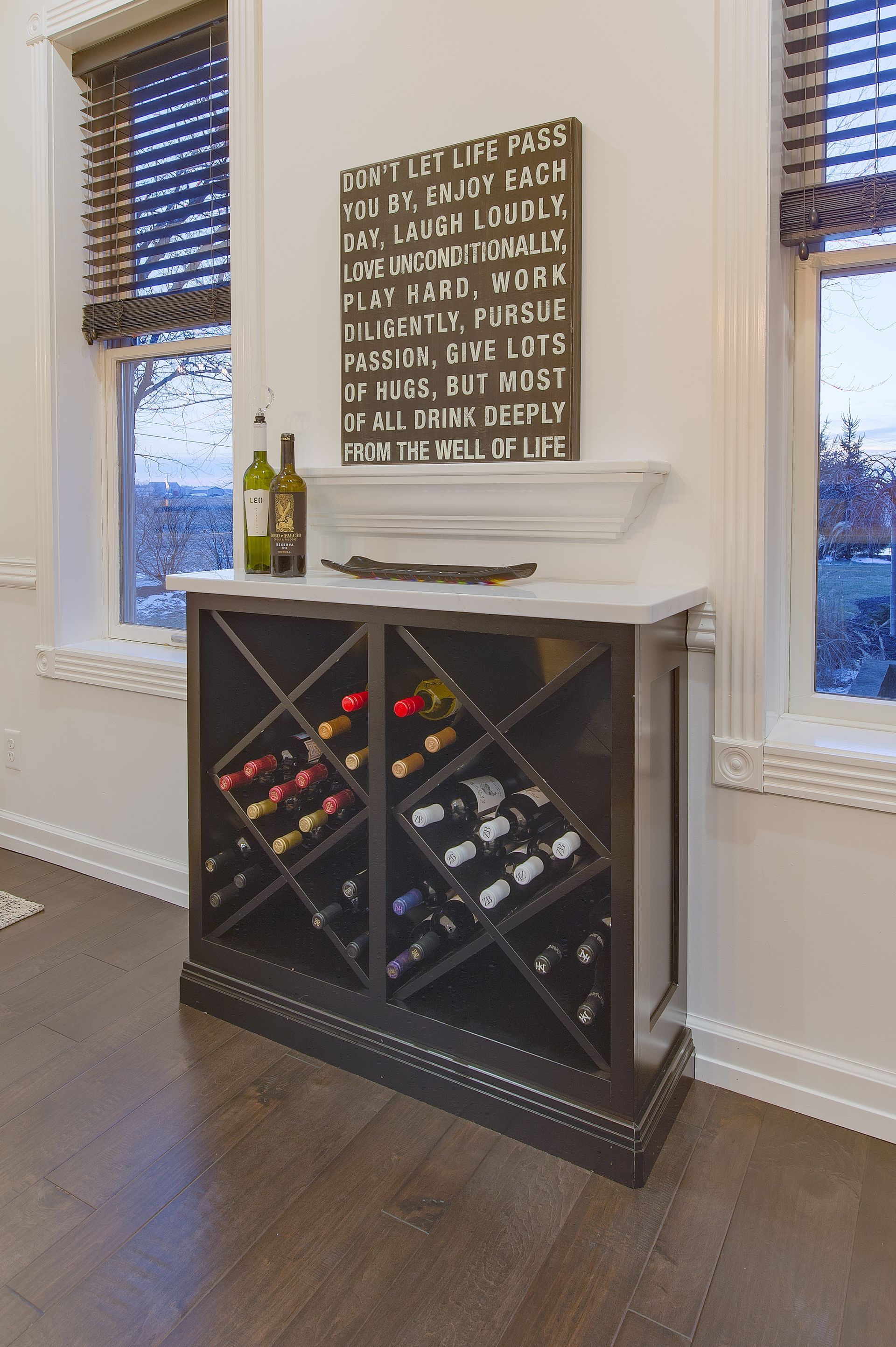 A wine rack filled with multiple bottles.
