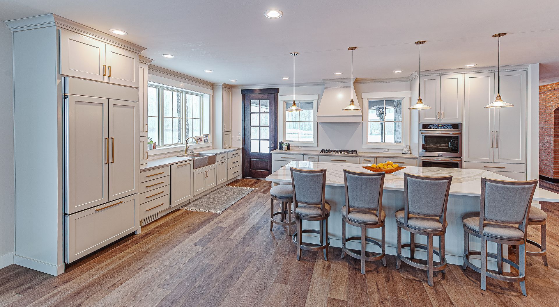 Sink and a wide set of windows, and a island table..
