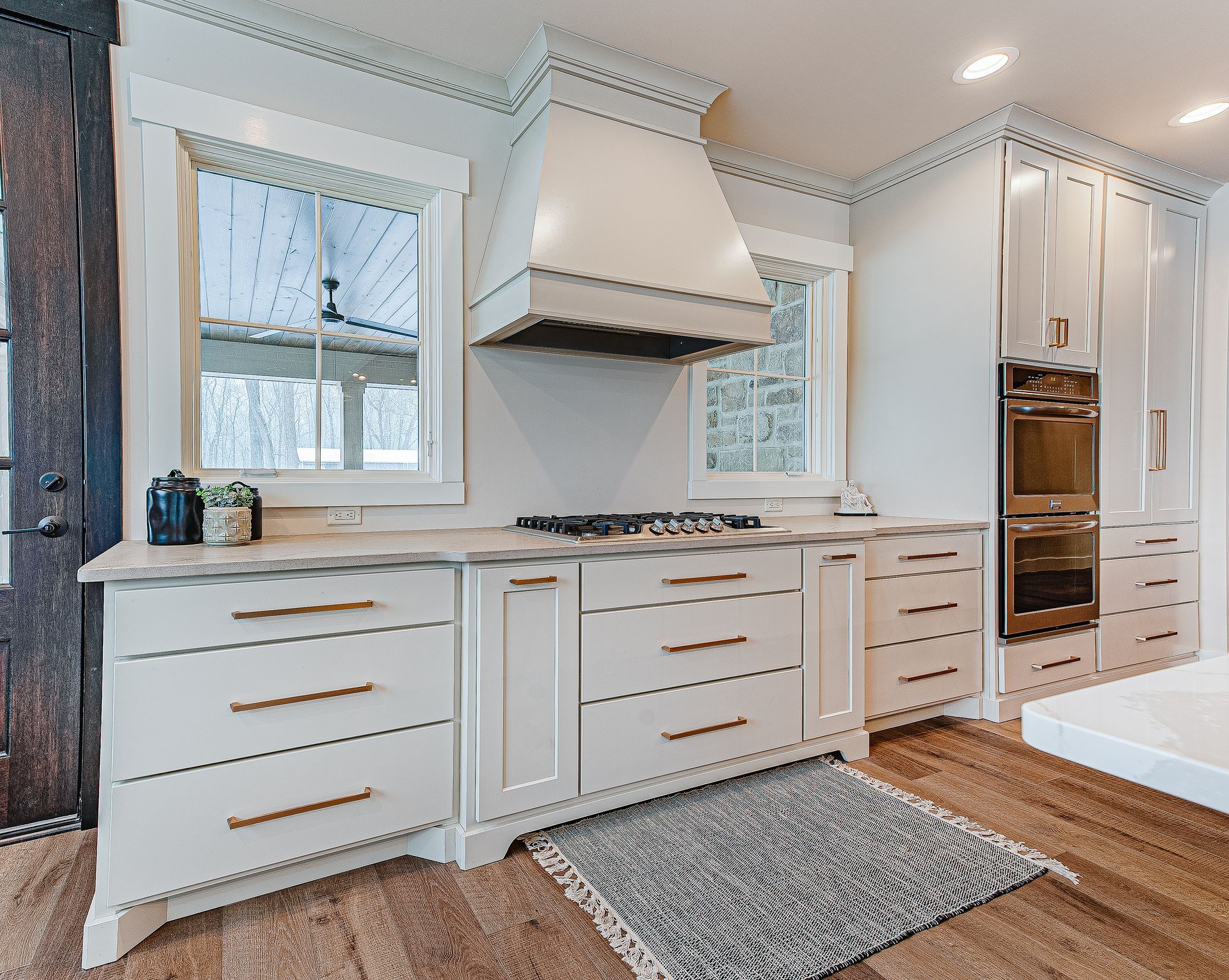 Stovetop with white cabinets.