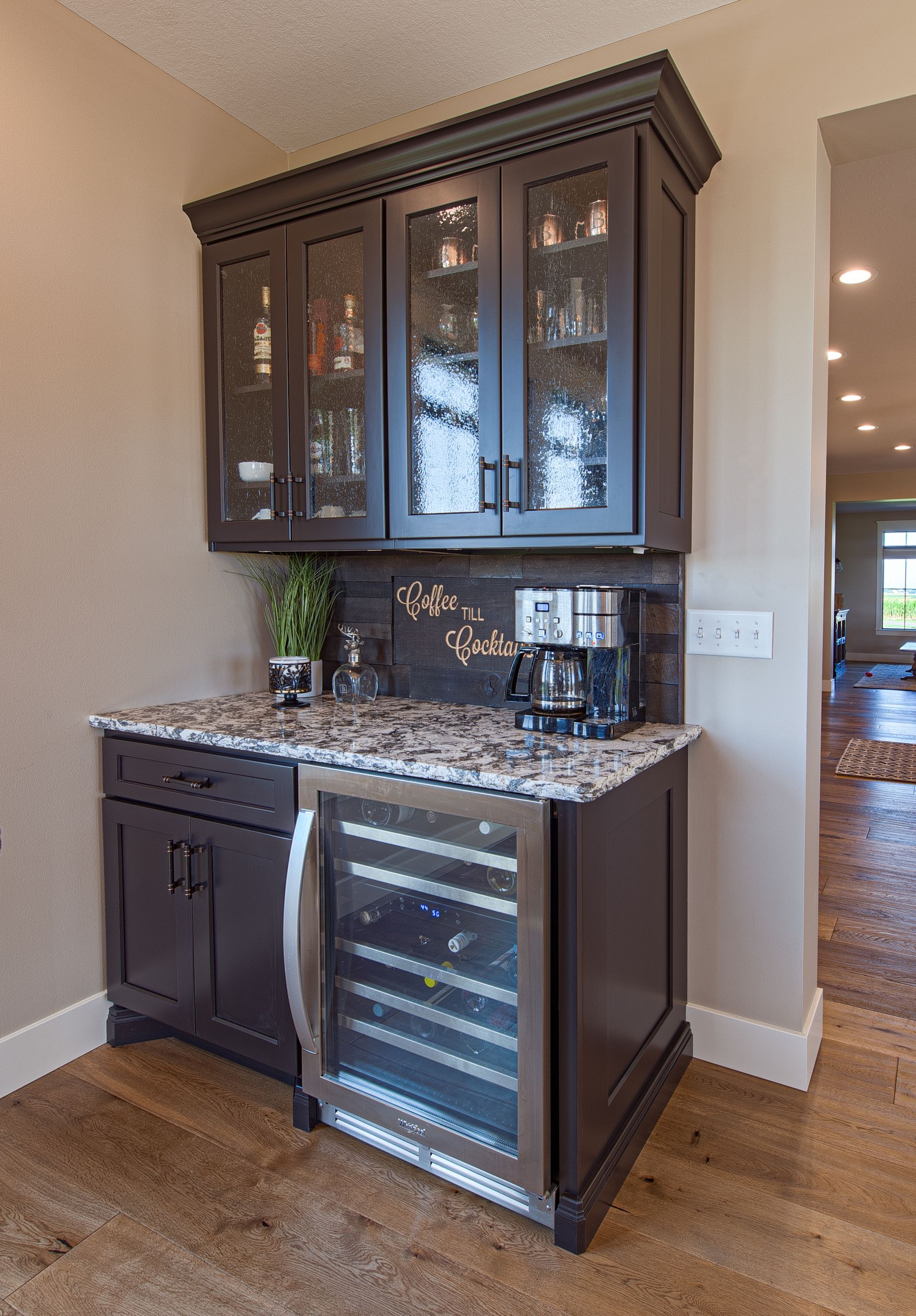 A mini bar with a mini fridge for drinks to mix together.