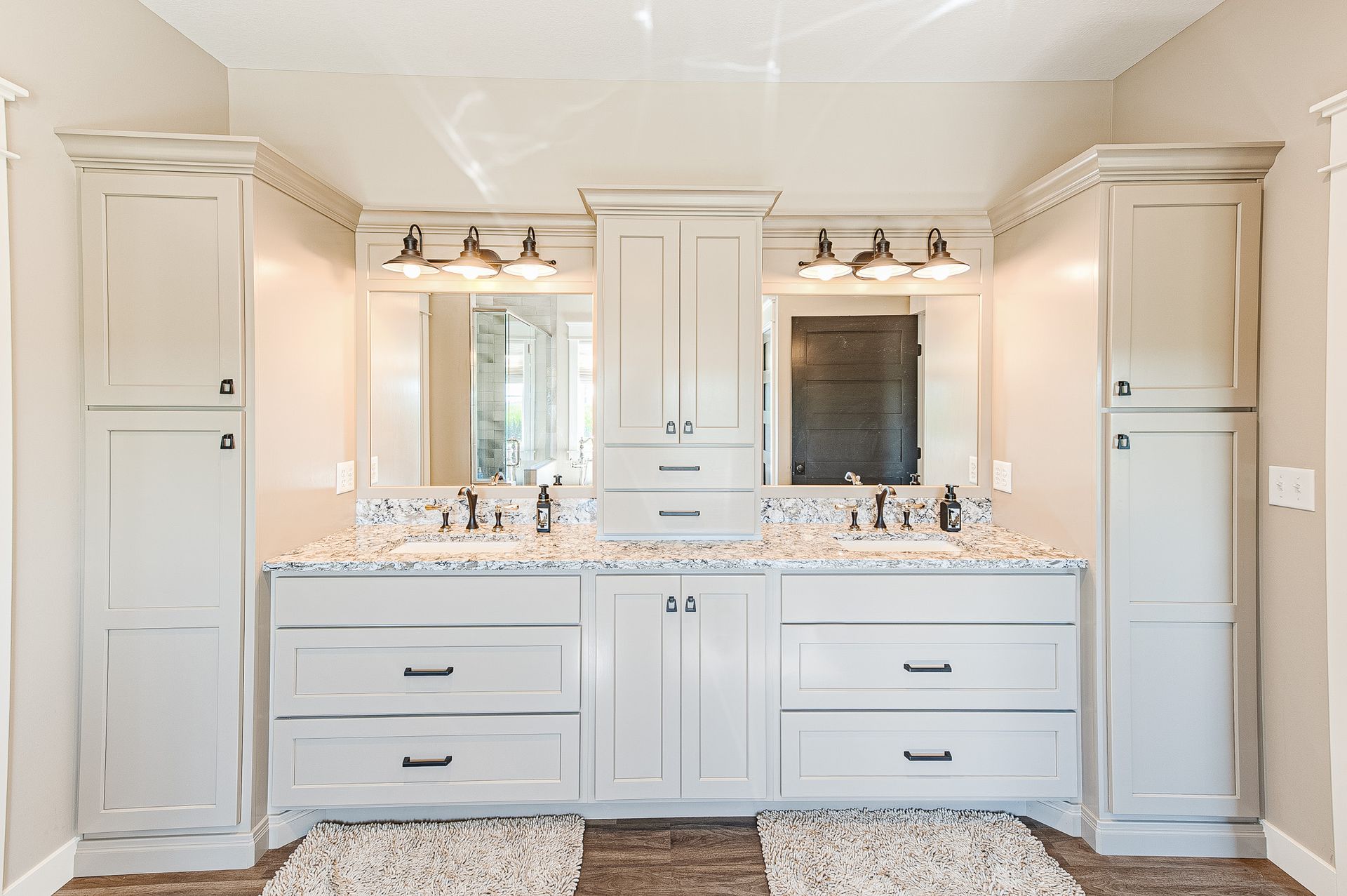 Two sinks with a cabinet set in between the two sinks.