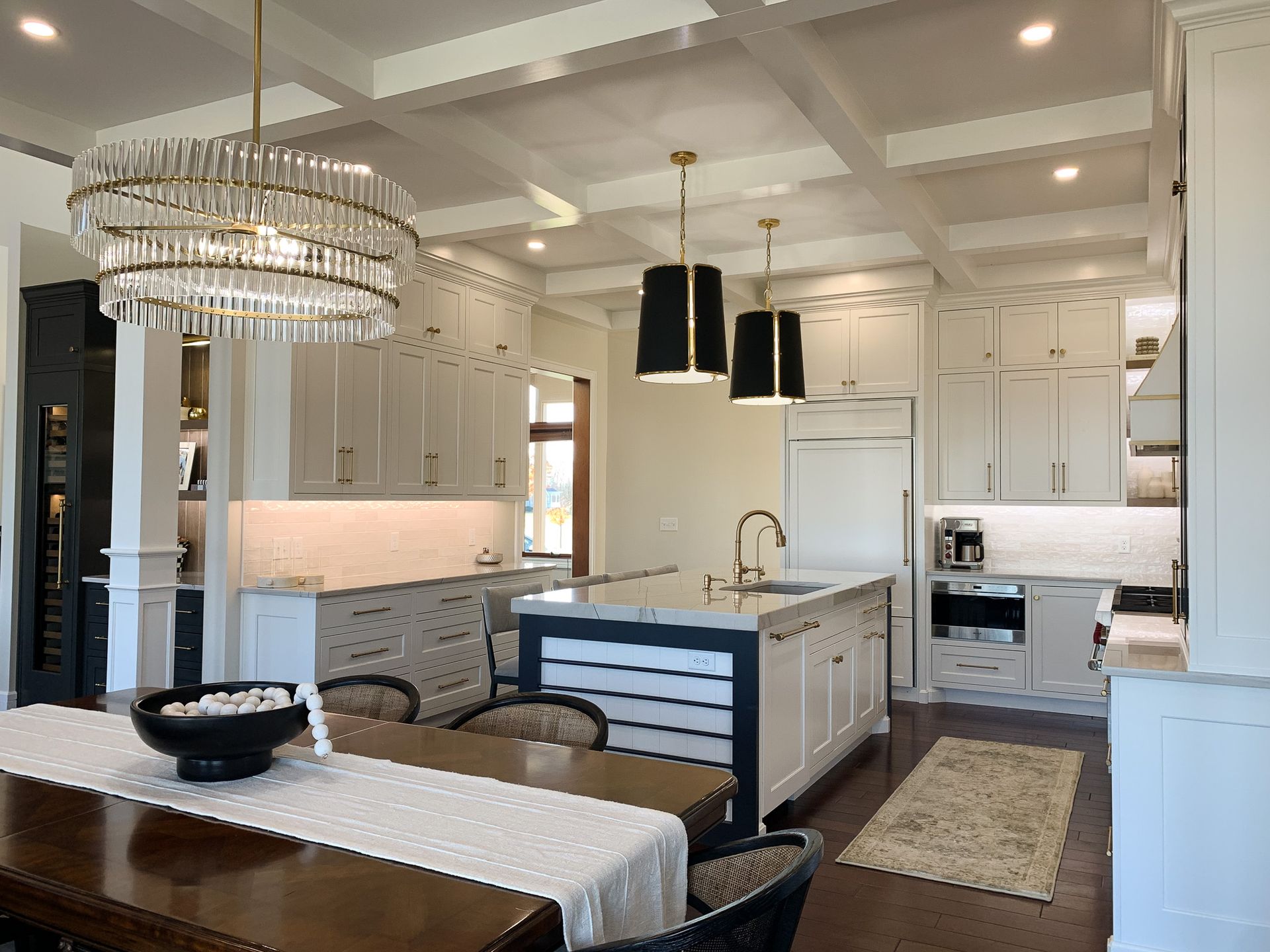 Kitchen with island table and sink. A dining table and chandelier