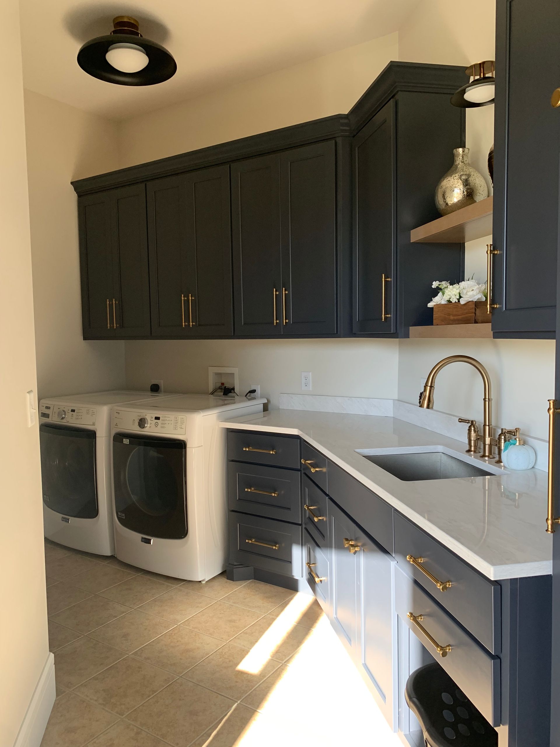 A mudroom with a washer dryer combo and a sink.