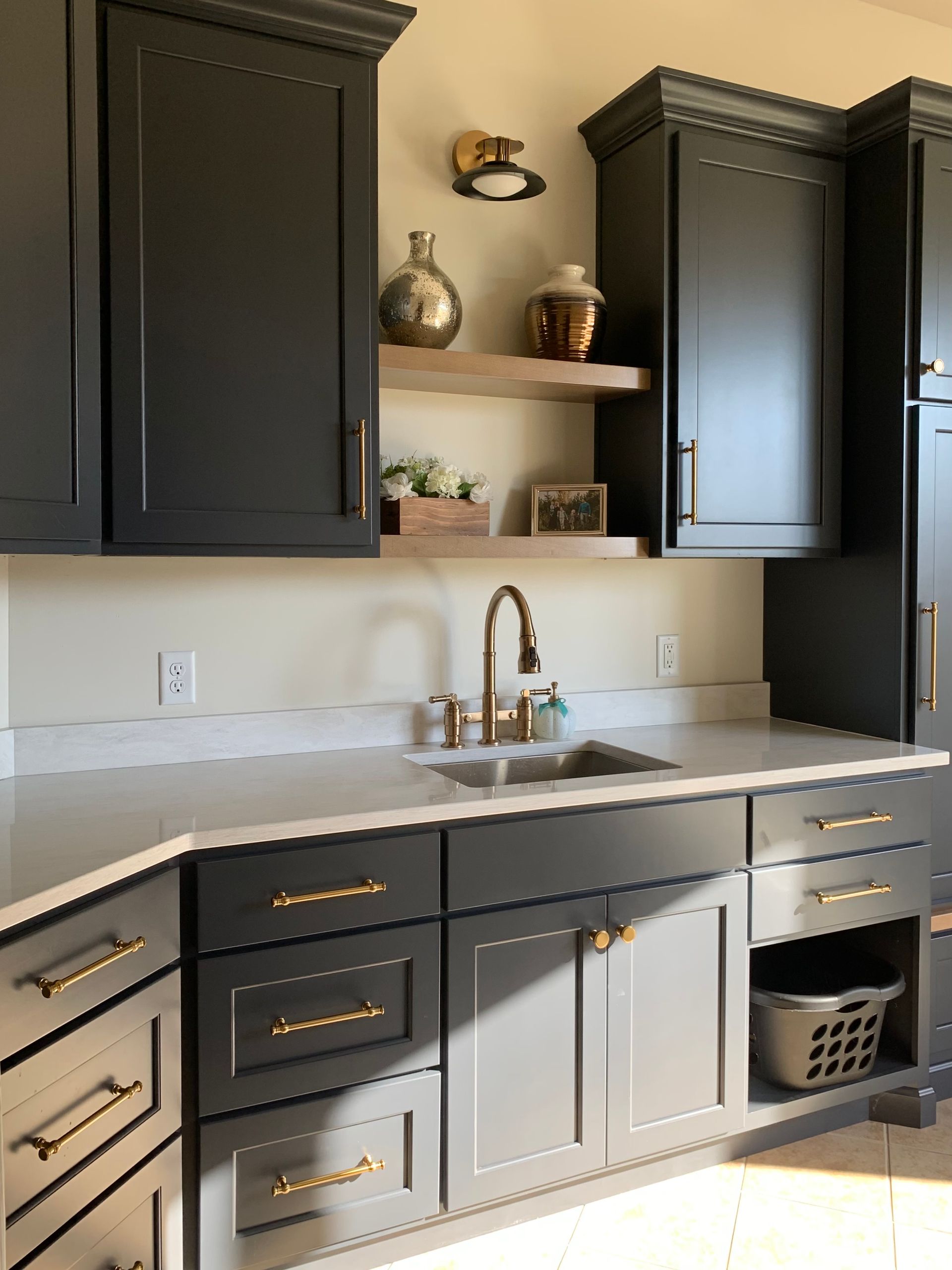 Mudroom laundry with a sink and cabinets for storage.