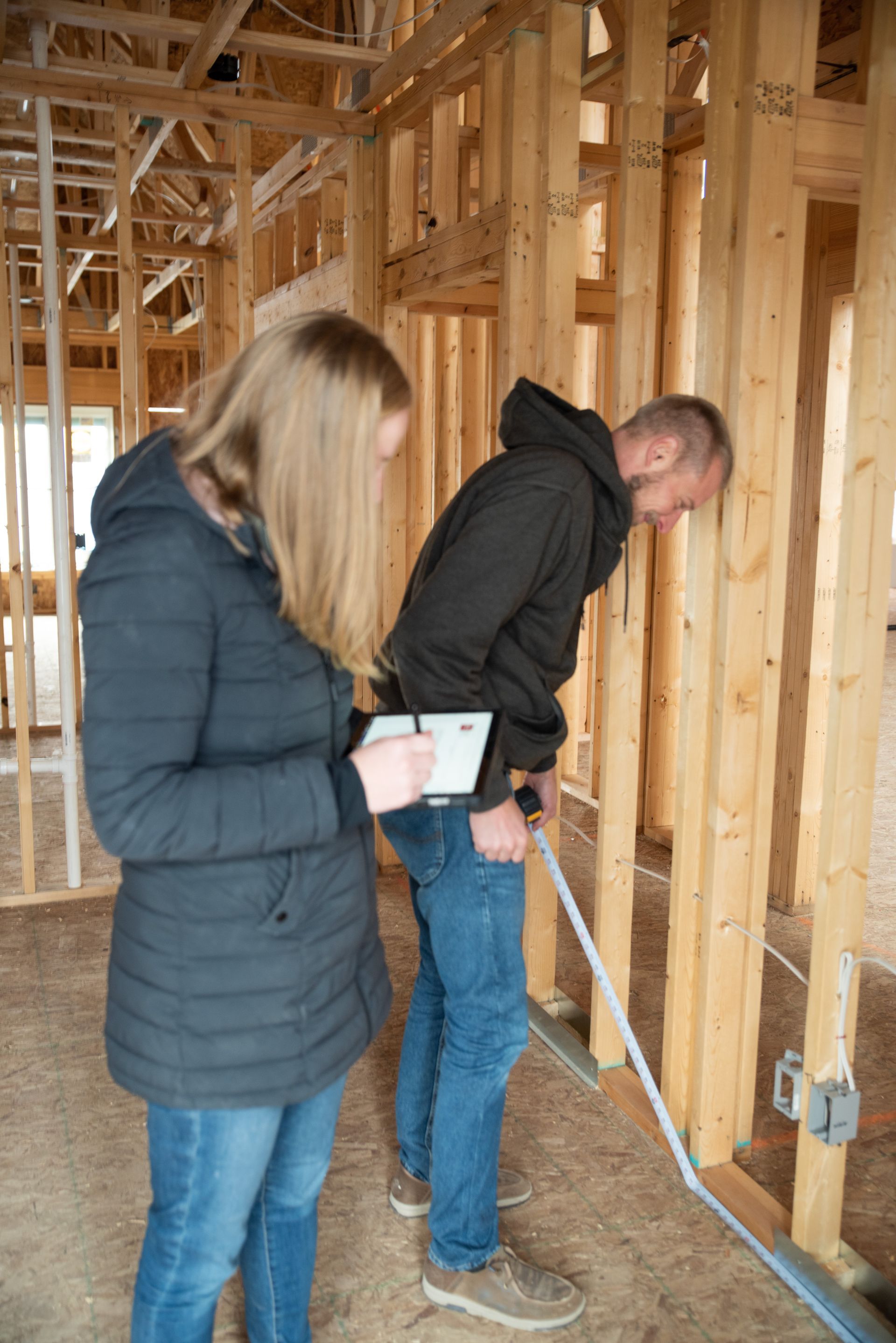 Measurements being made for setting up walls and electrical wiring.