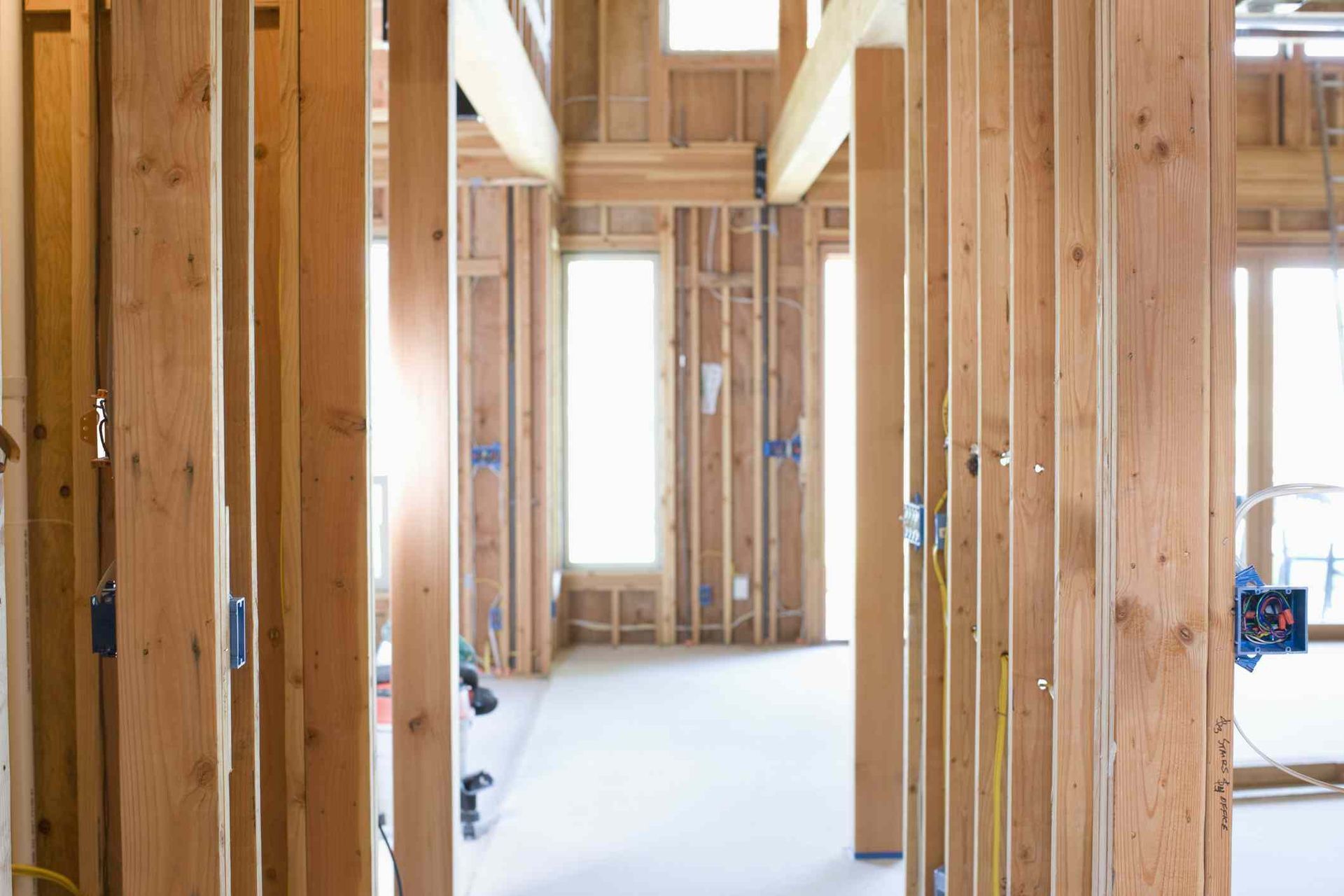 a house is being built with wooden beams and a measuring tape .