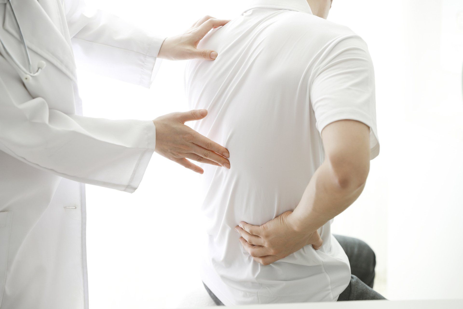Doctor Checking Patient's Backache — Hastings, NE — Adams County Chiropractic