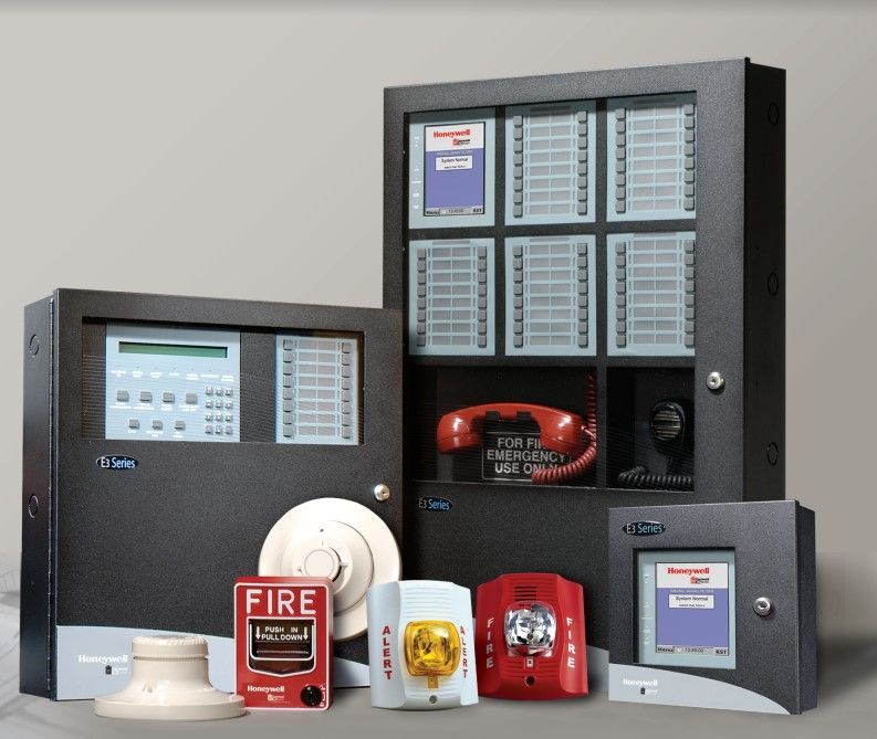 A group of fire alarm systems are stacked on top of each other on a white background.