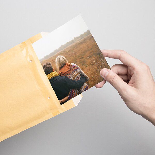 Hand holding an envelope with a picture