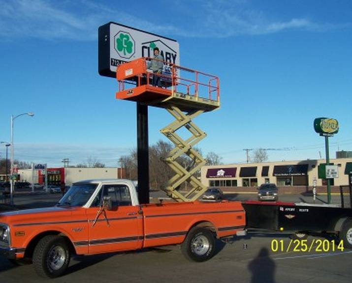 Man creating store sign - custom wood, aluminum & lighted signs in Council Bluffs, IA