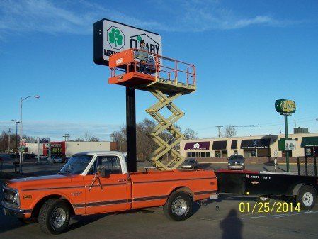 Man Installing sign - Custom signs contractor in Council Bluffs,IA