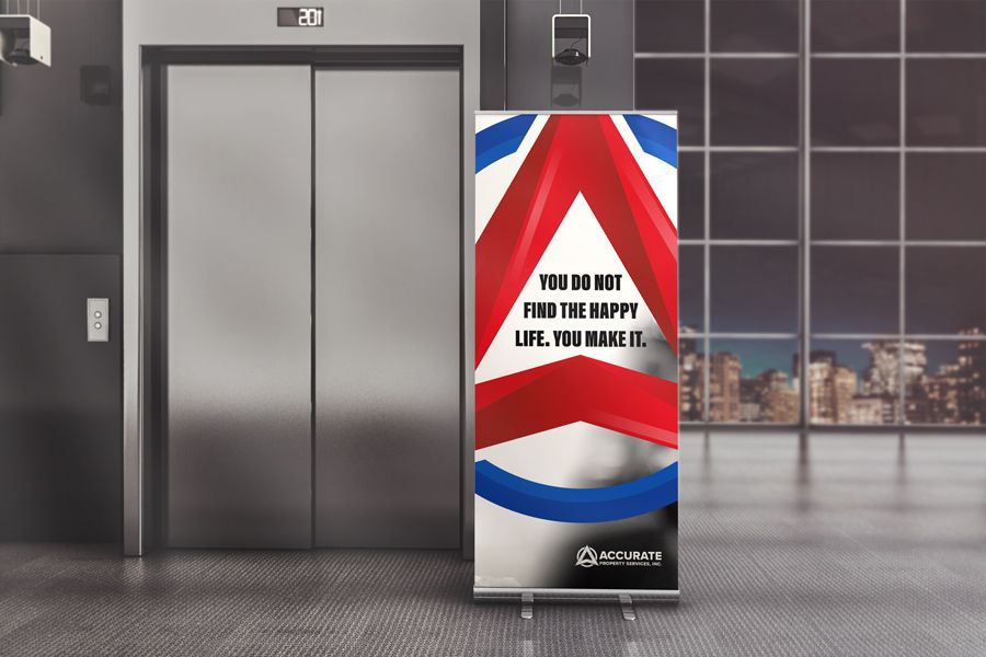 Elevator lobby with a patriotic red, white, and blue digital display kiosk showing a message.