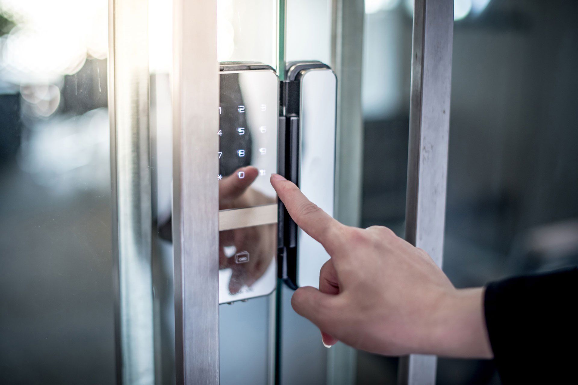 A person is pressing a button on a door with their finger.