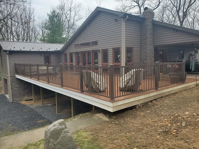 A house with a large deck on the side of it.