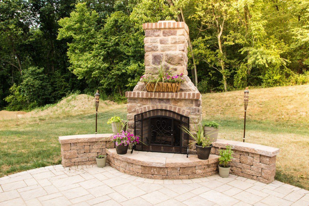 Fireplace with plant decoration — custom outdoor fireplace in Newville, PA